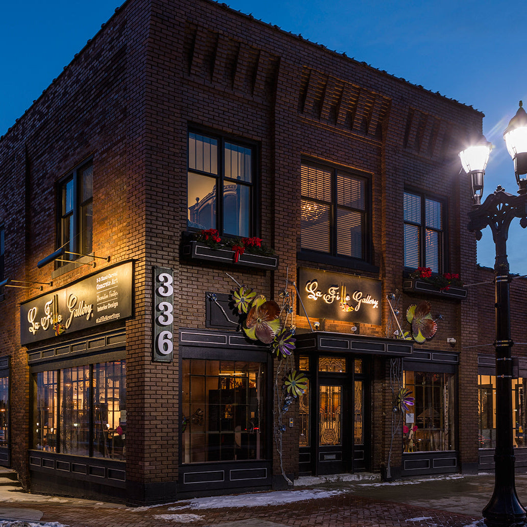 Brick building with illuminated signs at night