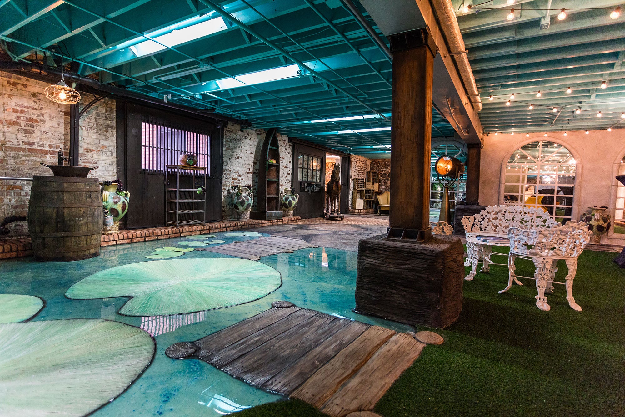 Indoor pool area with decorative lily pads and brick walls.