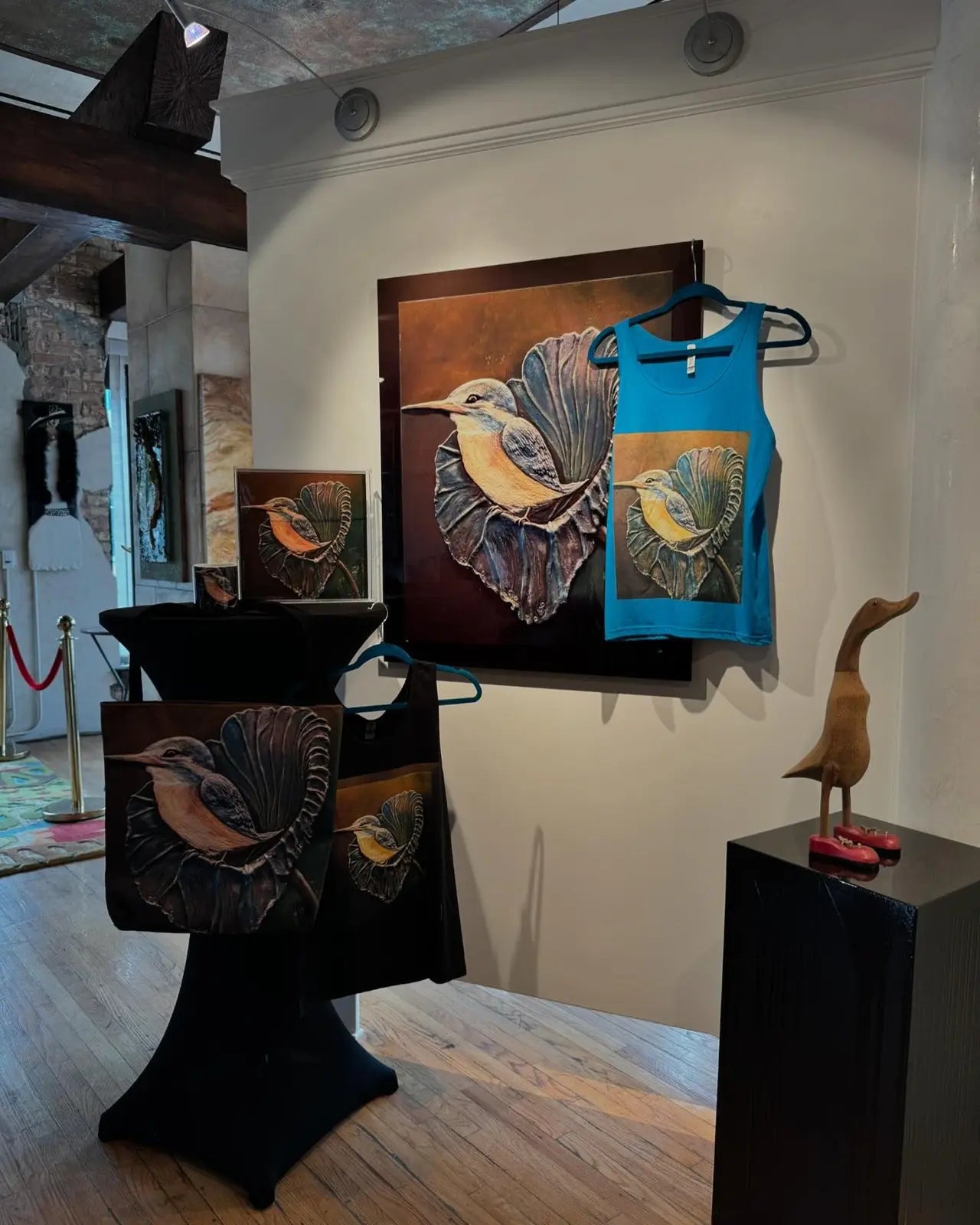 Artistic display of bird-themed clothing and decor in a store setting.